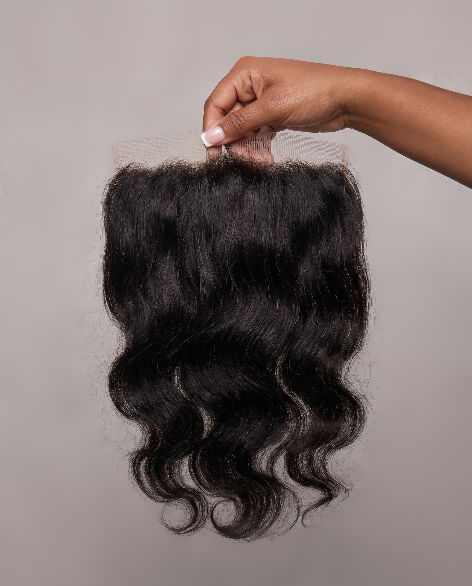 Raw lace frontal held up to show lace detail